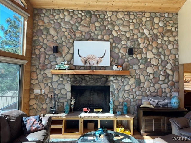 living room with wood ceiling, a fireplace, and wood finished floors