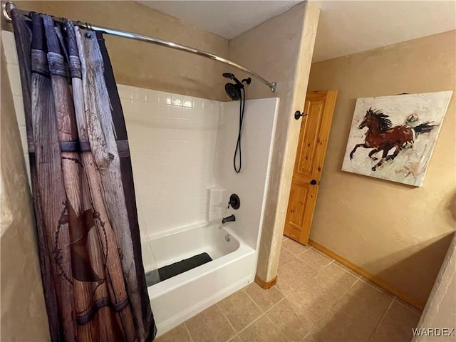 full bathroom with tile patterned flooring, shower / bath combo with shower curtain, and baseboards