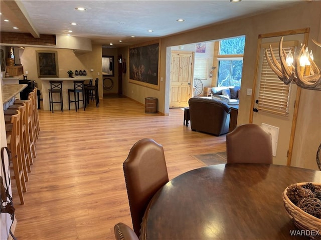 living area with light wood-type flooring and recessed lighting