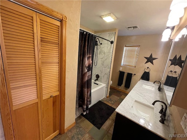 full bath featuring double vanity, shower / bath combination with curtain, a closet, visible vents, and a sink