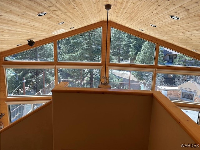 unfurnished sunroom with lofted ceiling, plenty of natural light, and wood ceiling