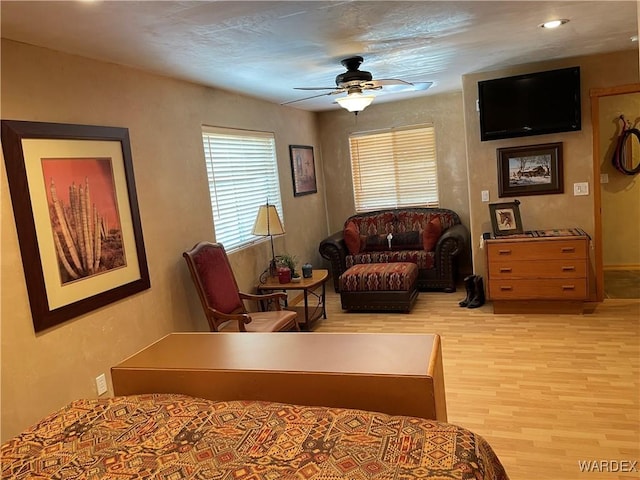 bedroom with a ceiling fan and light wood-style floors