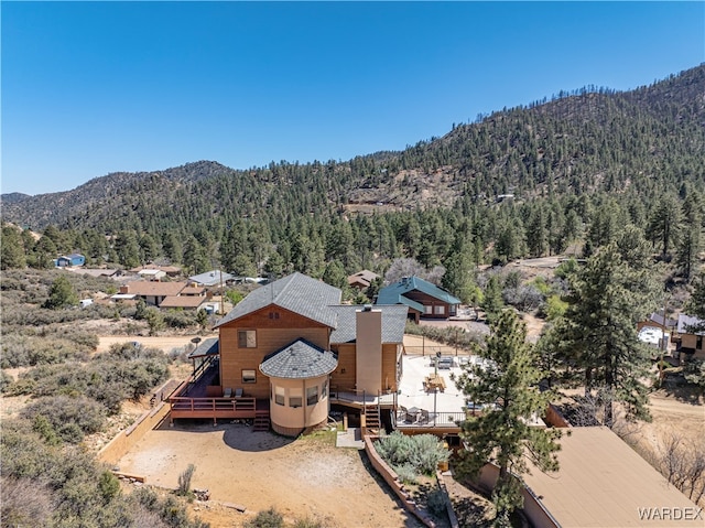 drone / aerial view with a mountain view and a view of trees