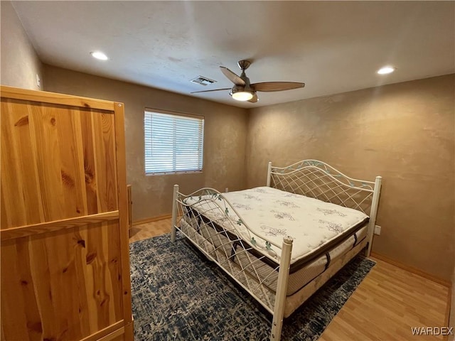 bedroom with a ceiling fan, wood finished floors, and recessed lighting