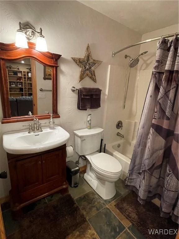 bathroom featuring toilet, shower / bath combo, and vanity