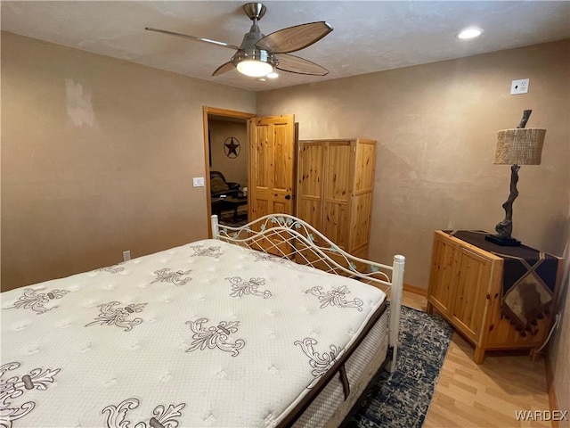 bedroom with light wood finished floors and ceiling fan