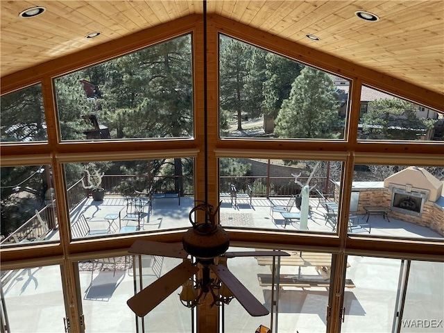 unfurnished sunroom featuring lofted ceiling and wooden ceiling