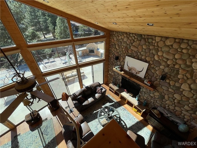 unfurnished living room with a wealth of natural light, a fireplace, wood ceiling, and recessed lighting