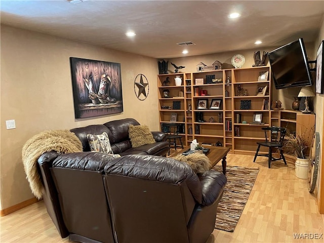 sitting room with light wood-type flooring, baseboards, visible vents, and recessed lighting