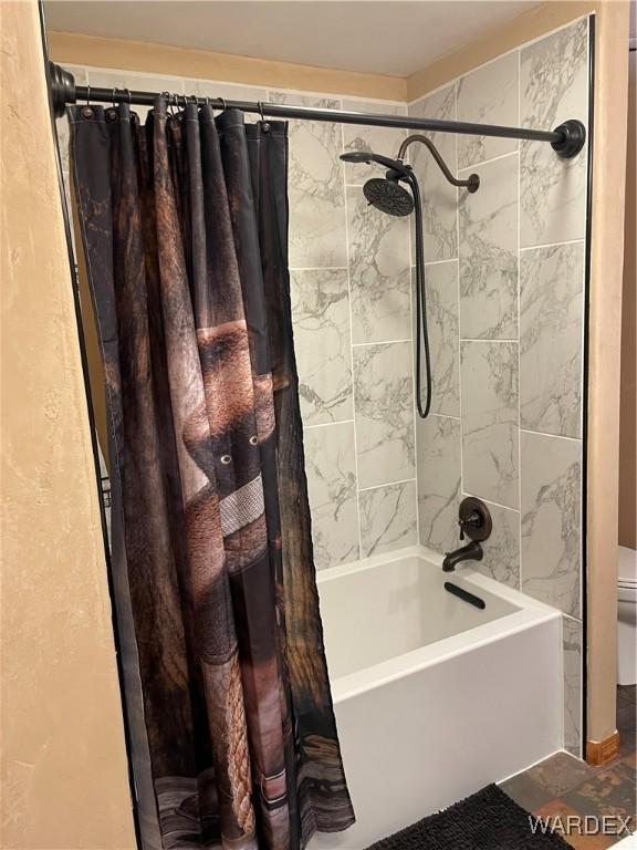 full bathroom with toilet and shower / tub combo with curtain