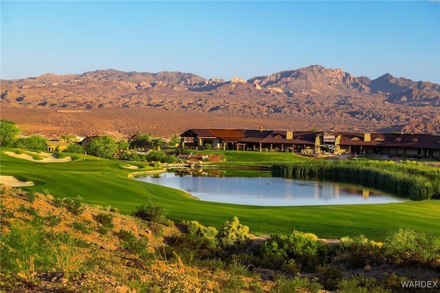 view of property's community featuring a yard, golf course view, and a water and mountain view