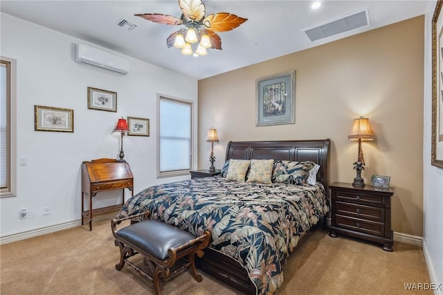 bedroom featuring baseboards, a wall unit AC, visible vents, and light colored carpet