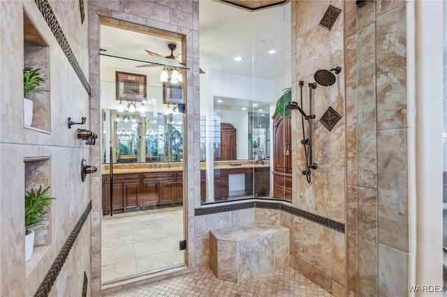 full bathroom with a stall shower, tile patterned floors, a ceiling fan, and vanity