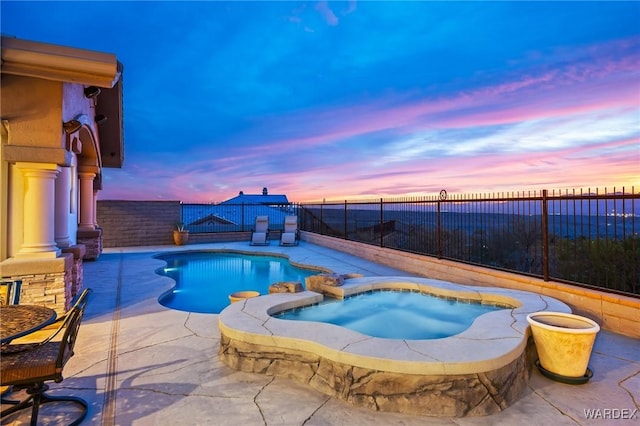 view of pool with a patio area, a fenced backyard, and a pool with connected hot tub