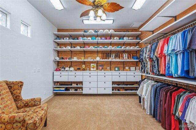 spacious closet featuring light carpet, ceiling fan, and visible vents