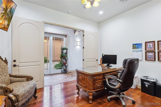 office featuring baseboards, visible vents, wood finished floors, an inviting chandelier, and recessed lighting