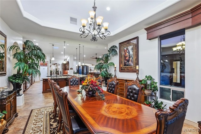 dining space with visible vents and a chandelier