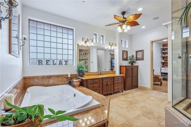 bathroom with a stall shower, ceiling fan, a whirlpool tub, vanity, and recessed lighting