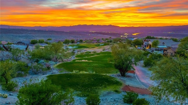 aerial view at dusk featuring a mountain view