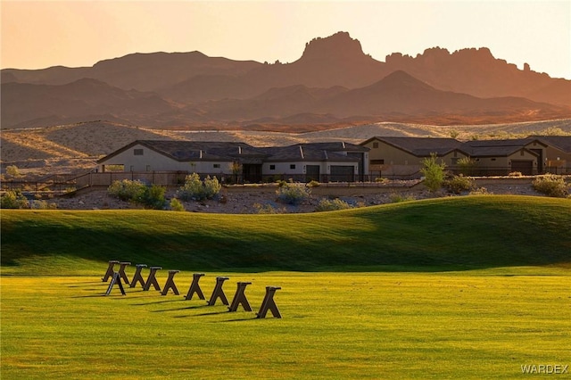 view of property's community with a mountain view and a yard