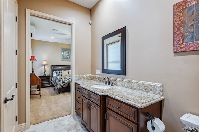 ensuite bathroom featuring visible vents, connected bathroom, and vanity