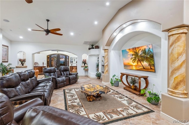 living room featuring arched walkways, lofted ceiling, recessed lighting, french doors, and ornate columns