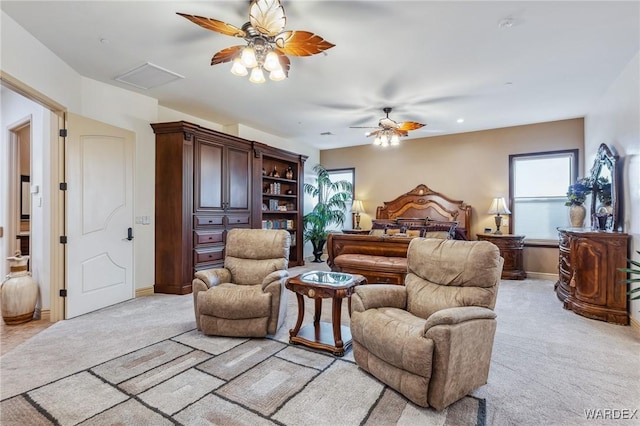 interior space featuring light carpet, baseboards, a ceiling fan, and attic access