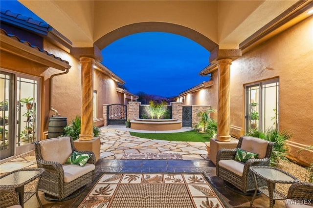 view of patio / terrace featuring french doors, fence, and a gate