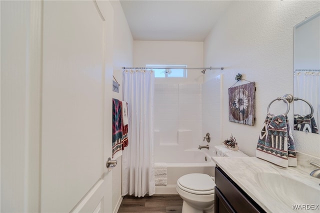 bathroom with toilet, shower / bath combo, wood finished floors, and vanity