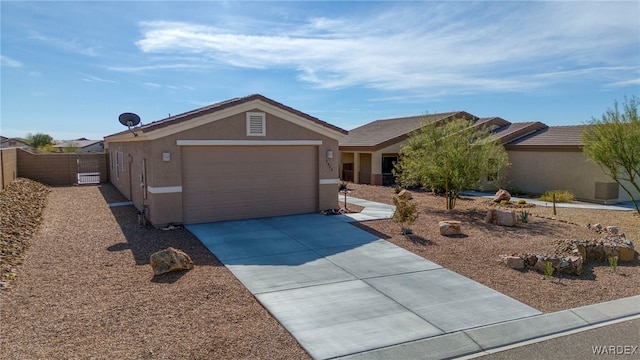 ranch-style home featuring a garage, concrete driveway, fence, and stucco siding