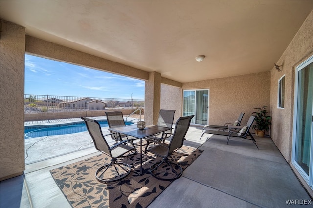 view of patio with fence, a fenced in pool, and outdoor dining space