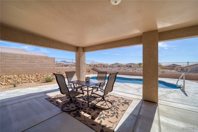 view of patio / terrace with a fenced backyard, a fenced in pool, and outdoor dining space