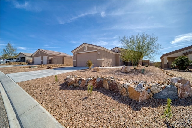 ranch-style home featuring a garage, concrete driveway, and stucco siding