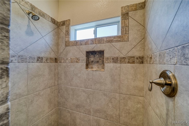 interior details featuring a tile shower