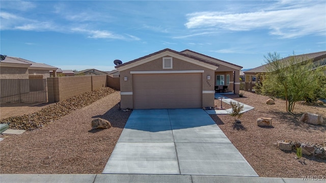 ranch-style home with a garage, concrete driveway, fence, and stucco siding