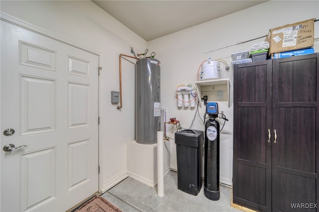 foyer entrance featuring water heater and baseboards