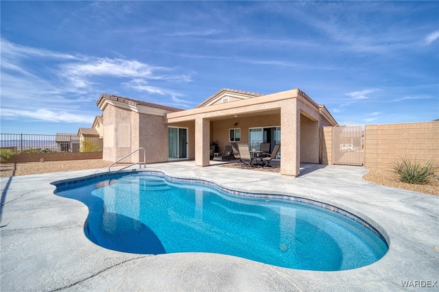 view of pool featuring a patio, fence, a gate, and a fenced in pool