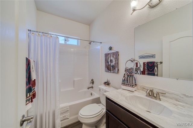 full bathroom featuring shower / bath combo, vanity, and toilet