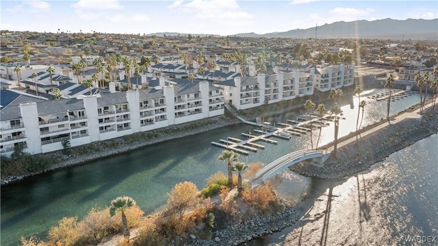 birds eye view of property with a water and mountain view