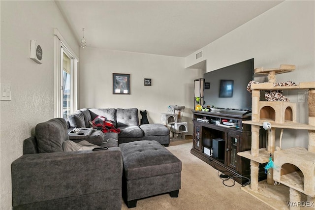 living area with light colored carpet and visible vents