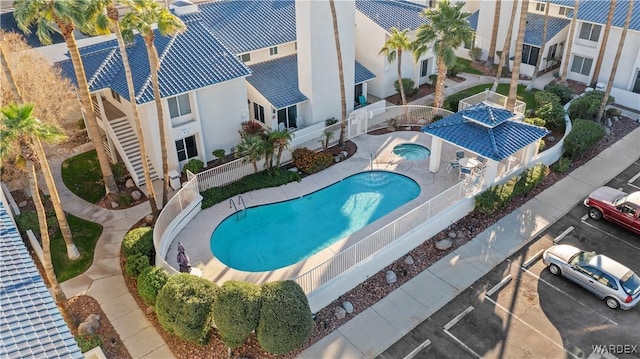 community pool featuring fence and a patio