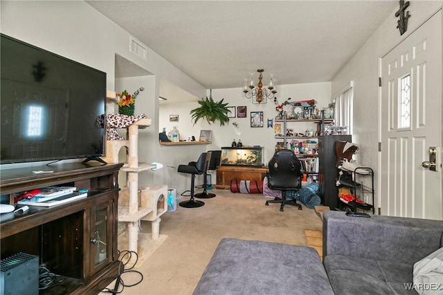 home office with a textured ceiling, an inviting chandelier, visible vents, and light colored carpet