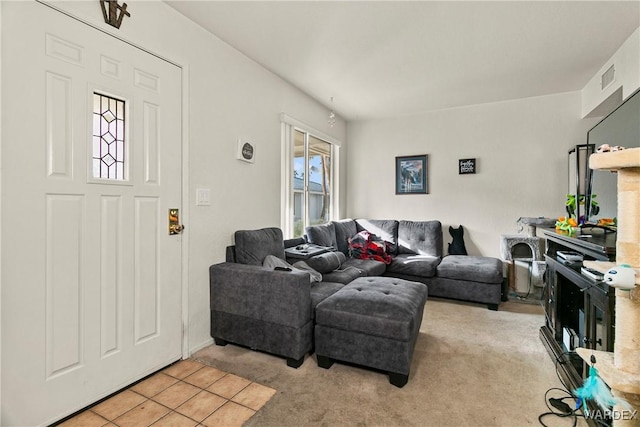 living area featuring visible vents and light colored carpet