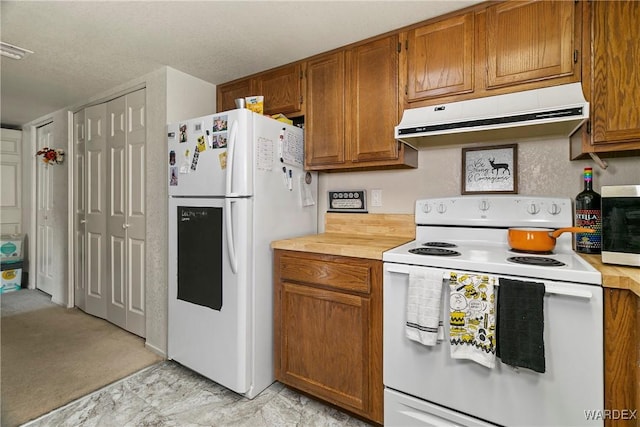 kitchen featuring light countertops, brown cabinetry, a textured ceiling, white appliances, and under cabinet range hood