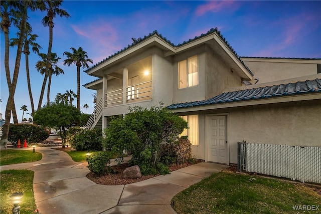 view of property featuring a balcony and stucco siding