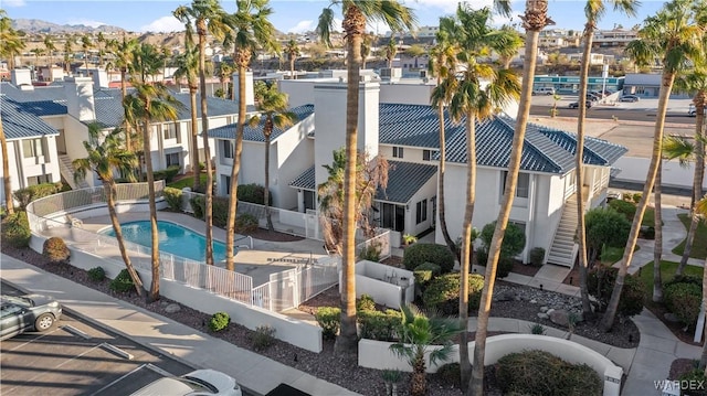 community pool featuring a residential view and stairs