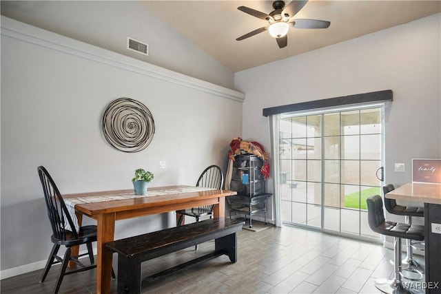 dining area featuring ceiling fan, visible vents, wood finished floors, and lofted ceiling