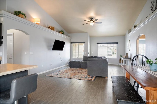 living room featuring arched walkways, ceiling fan, wood finished floors, and lofted ceiling