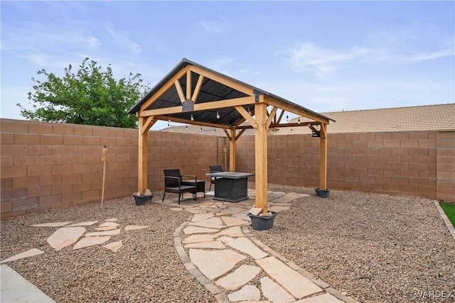 view of yard featuring a fenced backyard, a patio, and a gazebo