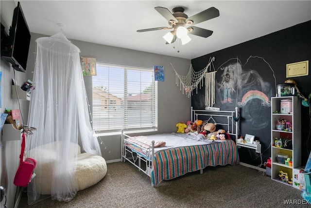 carpeted bedroom featuring baseboards and ceiling fan
